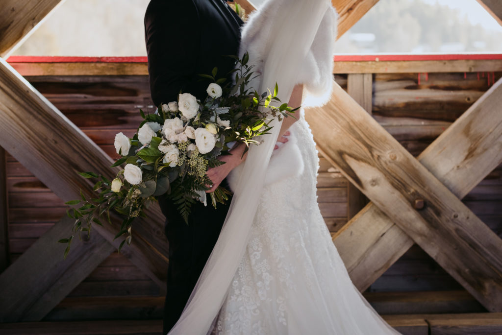 bride and groom standing inside the wakefield covered bridge