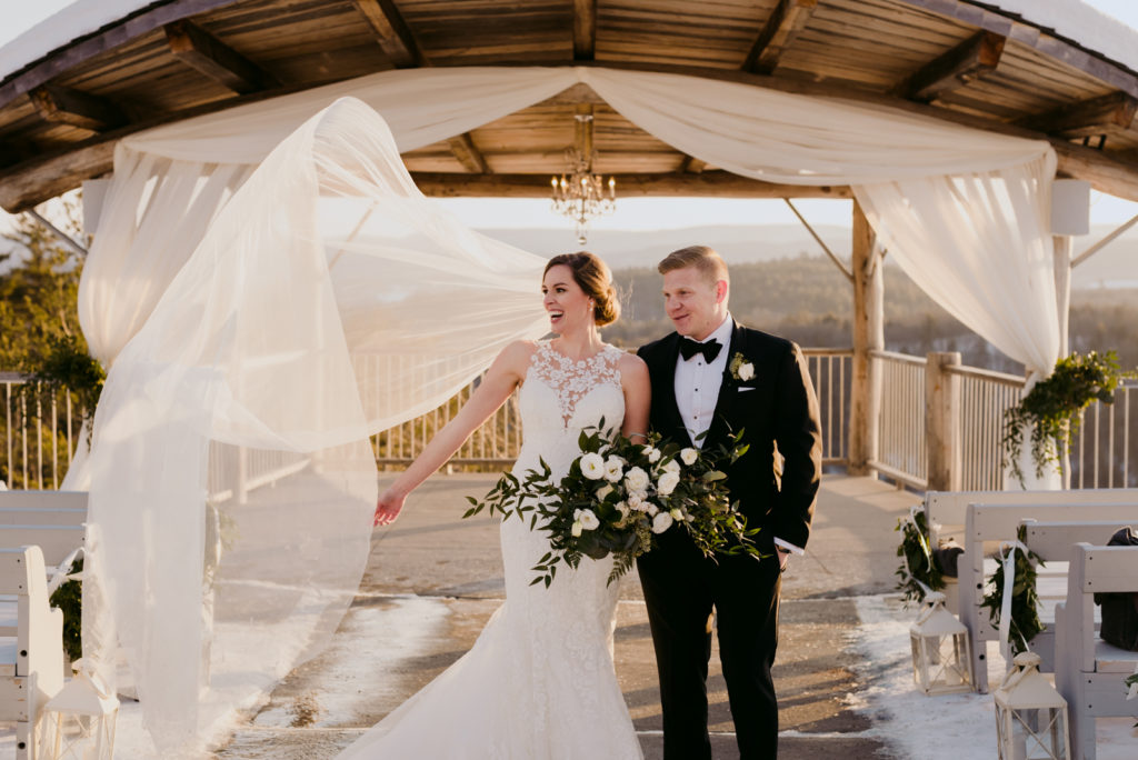 bride's cathedral veil blowing in the wind during sunset at le belvedere in wakefield