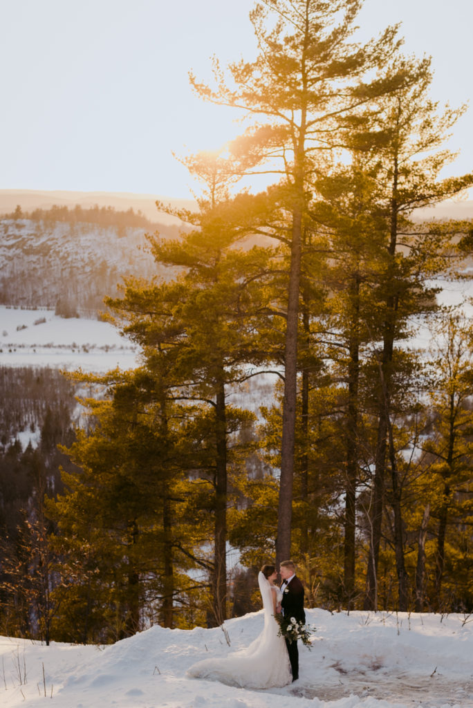 bride and groom overlooking the gatineau hills at sunset at le belvedere winter wedding