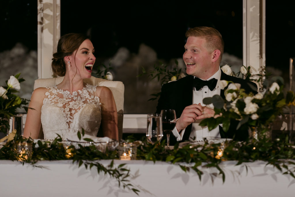 bride and groom laughing during speeches at Le Belvedere