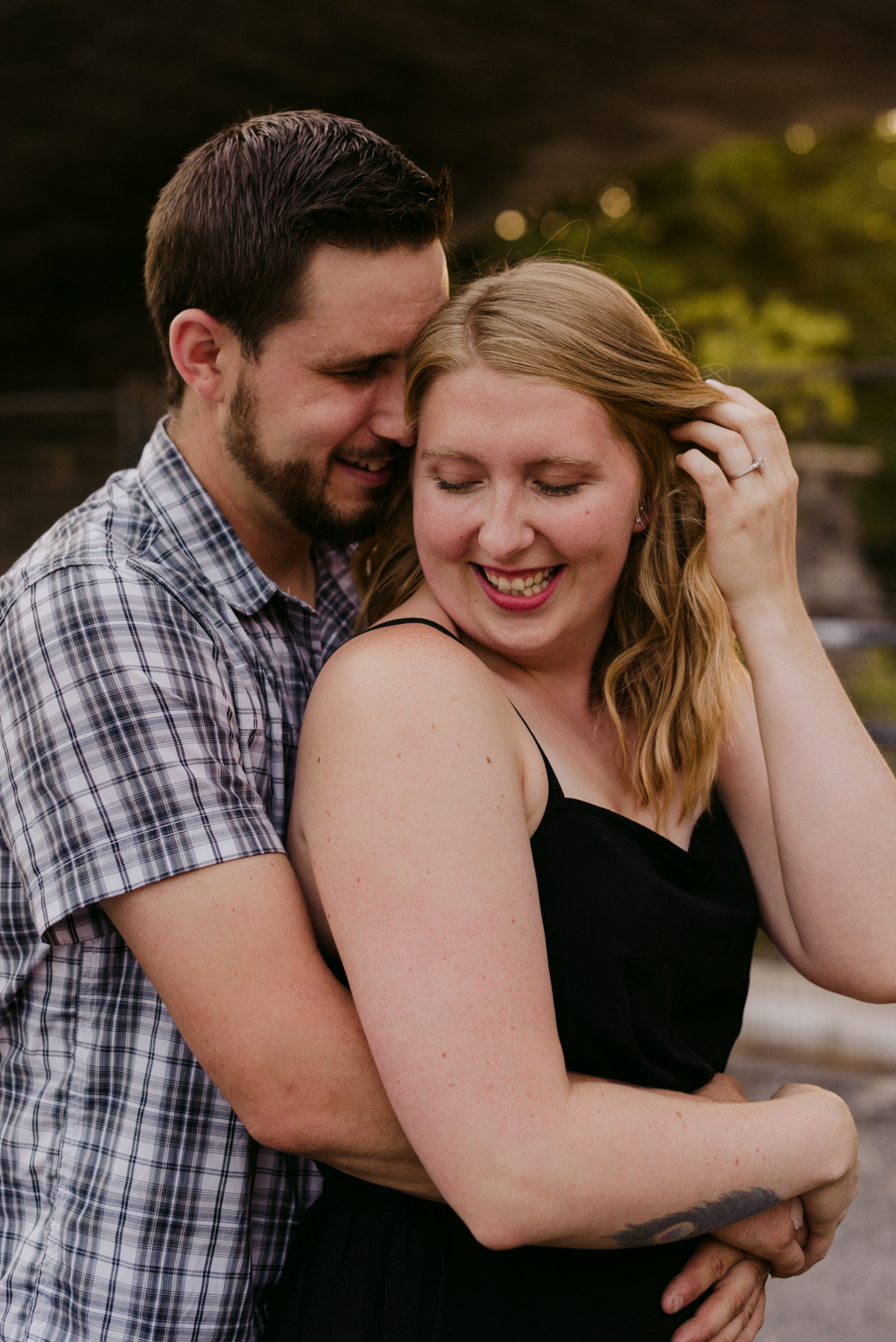 engaged couple hugging and smiling