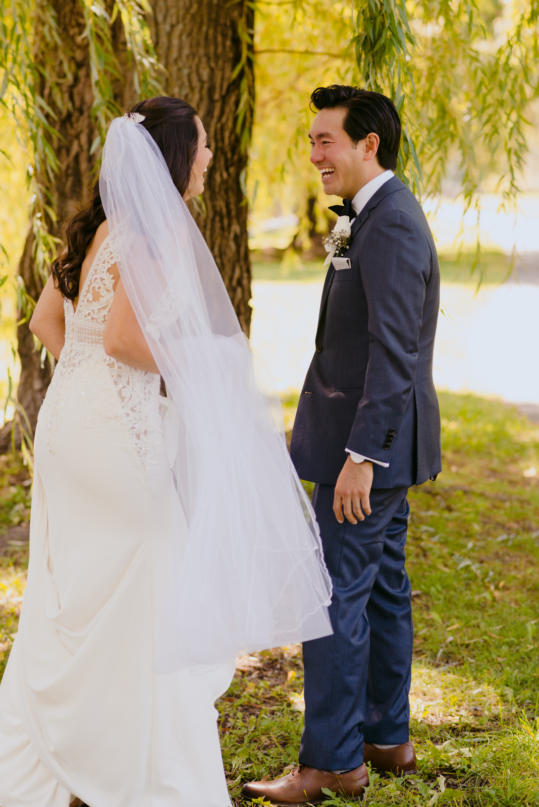 groom smiling at bride during first look by patterson's creek