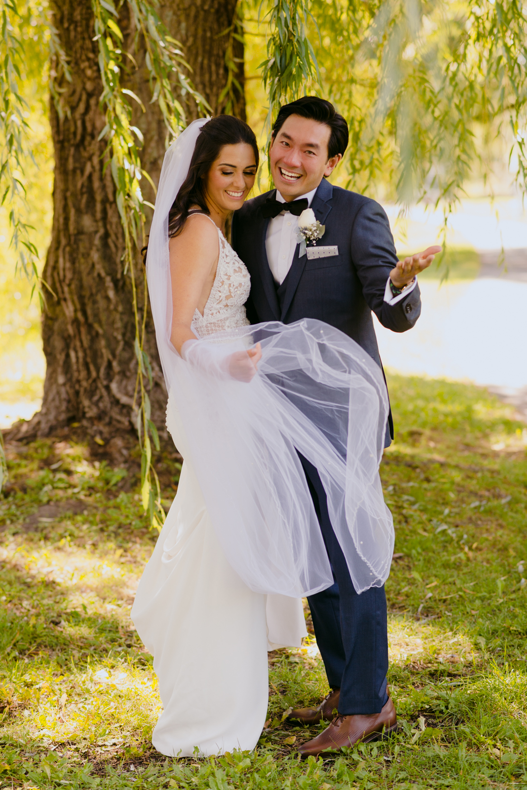 groom laughing at the camera after crying during first look by patterson's creek