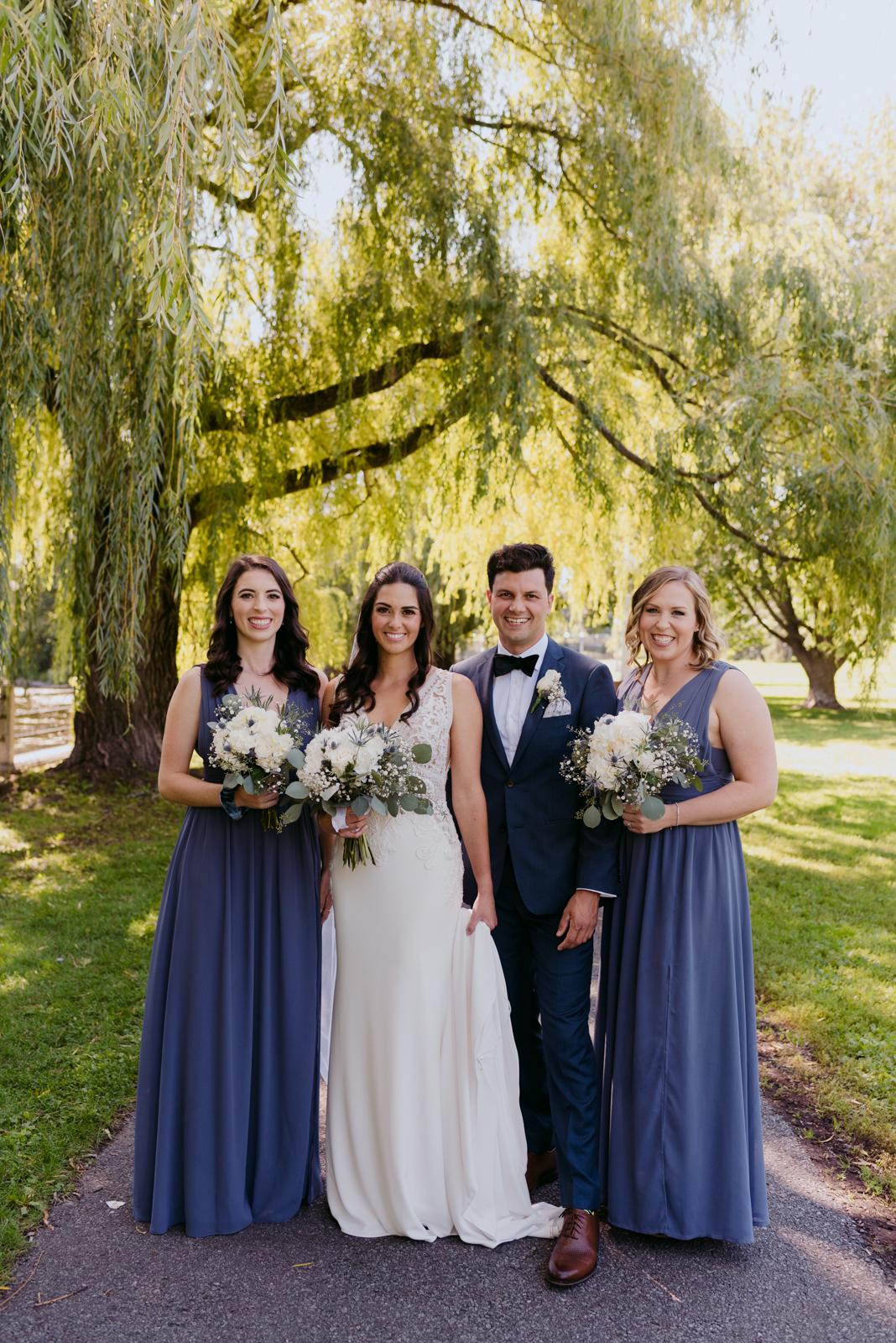 bride and bridal party by the willow trees by patterson's creek