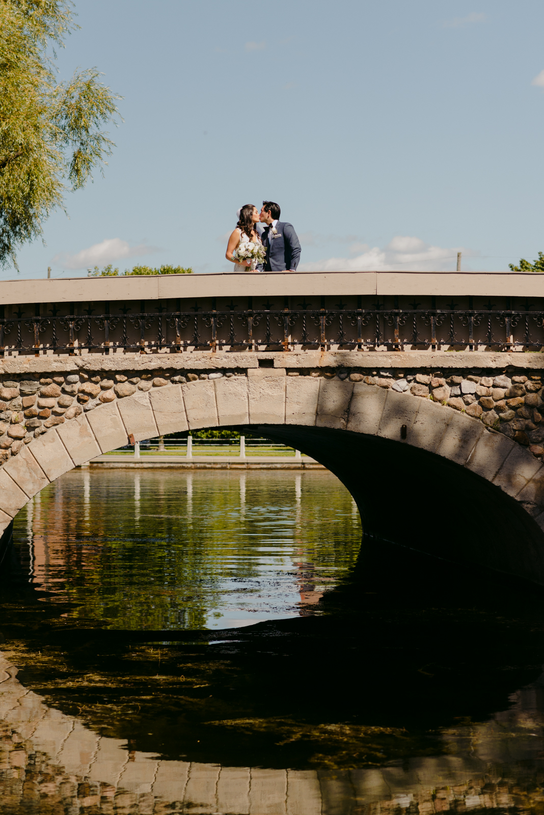 bride and groom on the bridge of the canal by patterson's creek