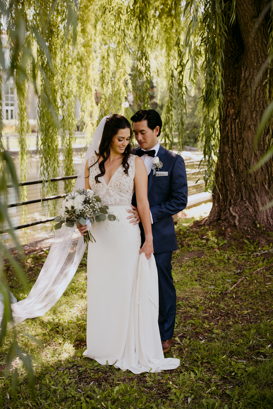 bride and groom in the willow trees by patterson's creek