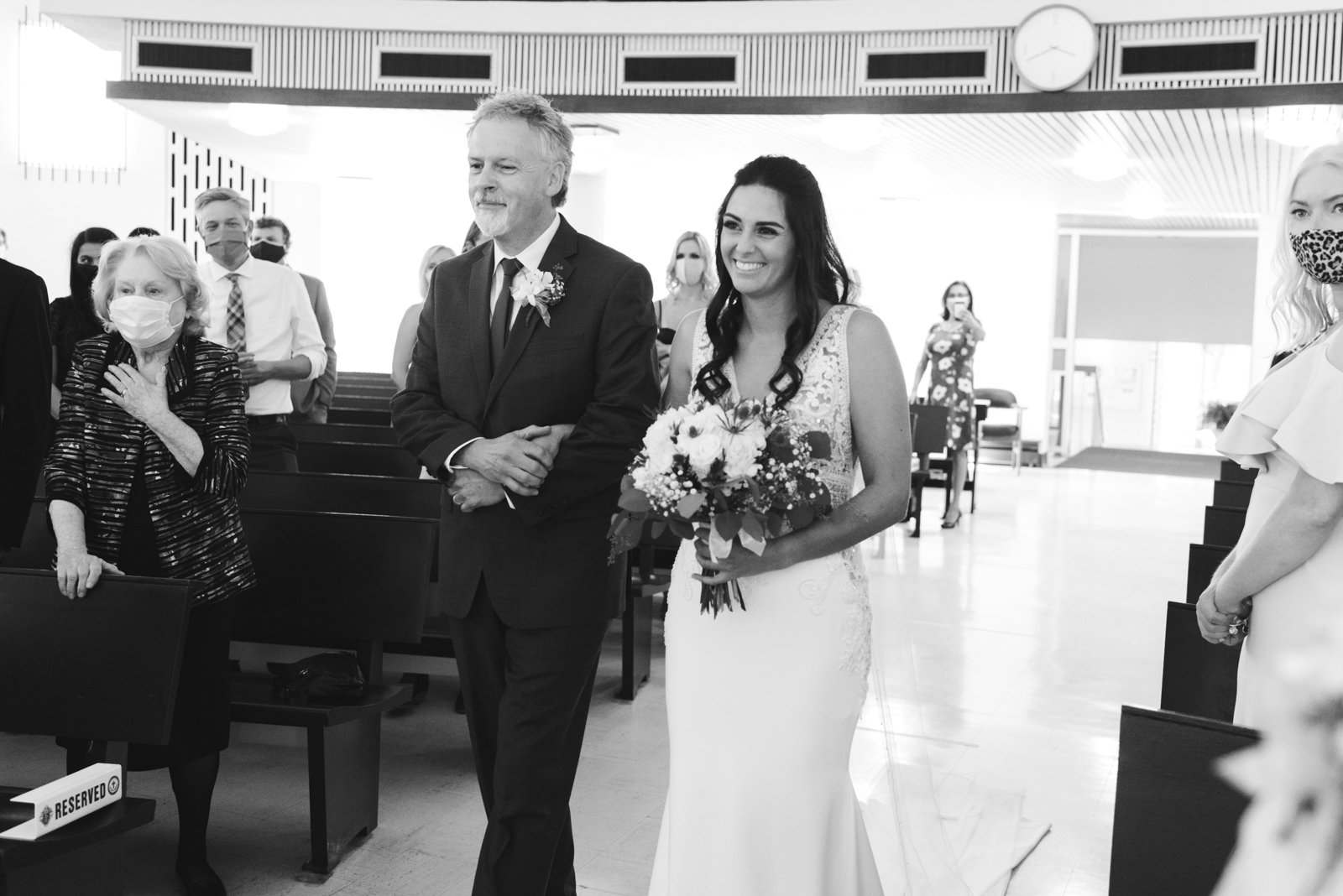 bride and her father walking down the aisle during wedding ceremony at St Basil's Church