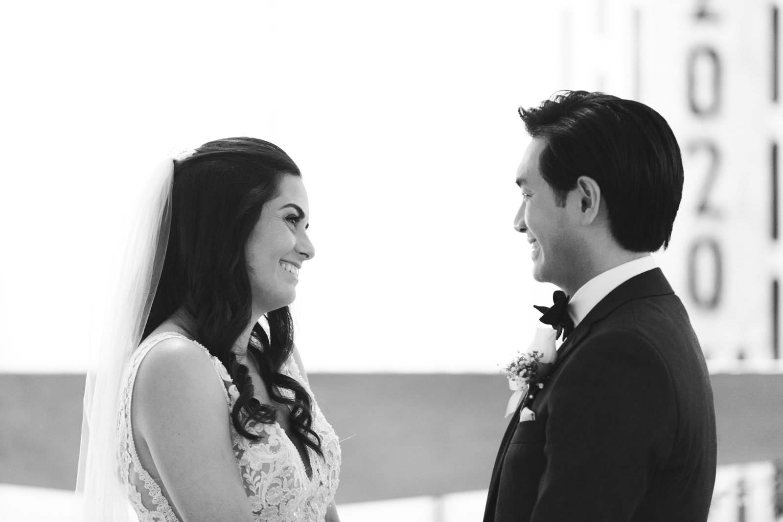 bride and groom smiling at each other during wedding ceremony at St Basil's Church