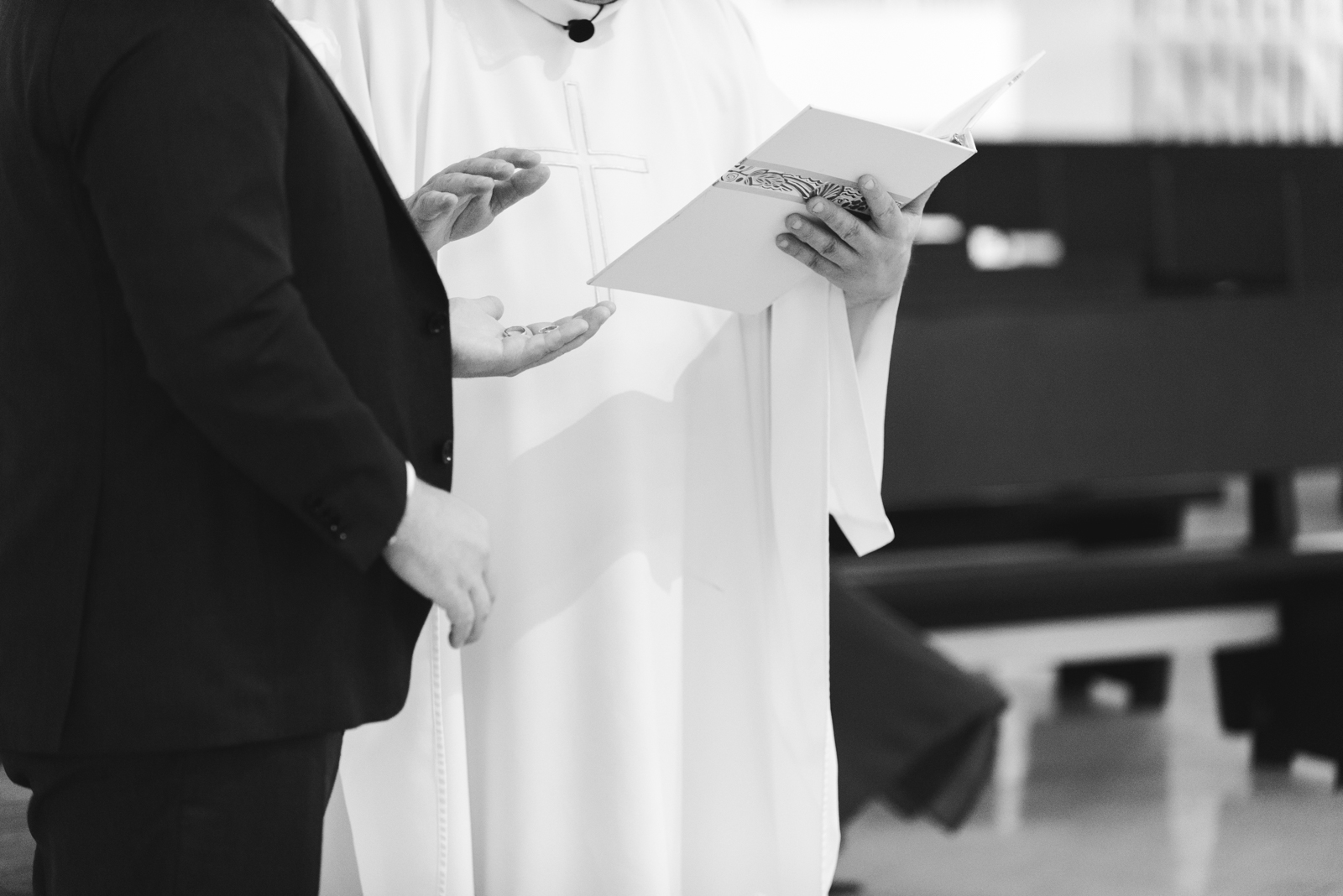 priest blessing the wedding bands during wedding ceremony at St Basil's Church