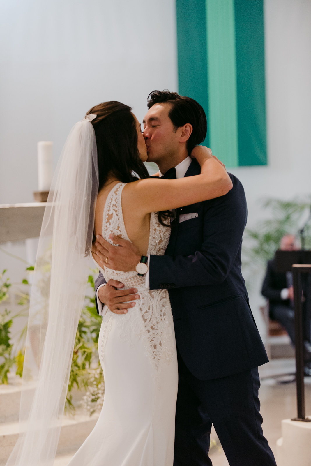 bride and groom first kiss during wedding ceremony at St Basil's Church