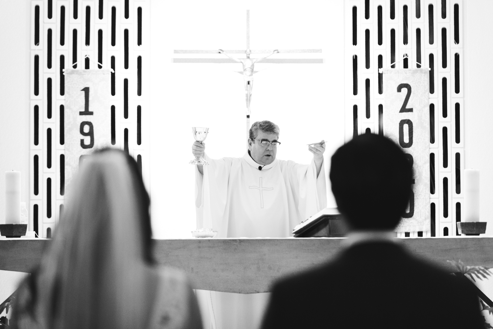 priest preparing communion during wedding ceremony at St Basil's Church