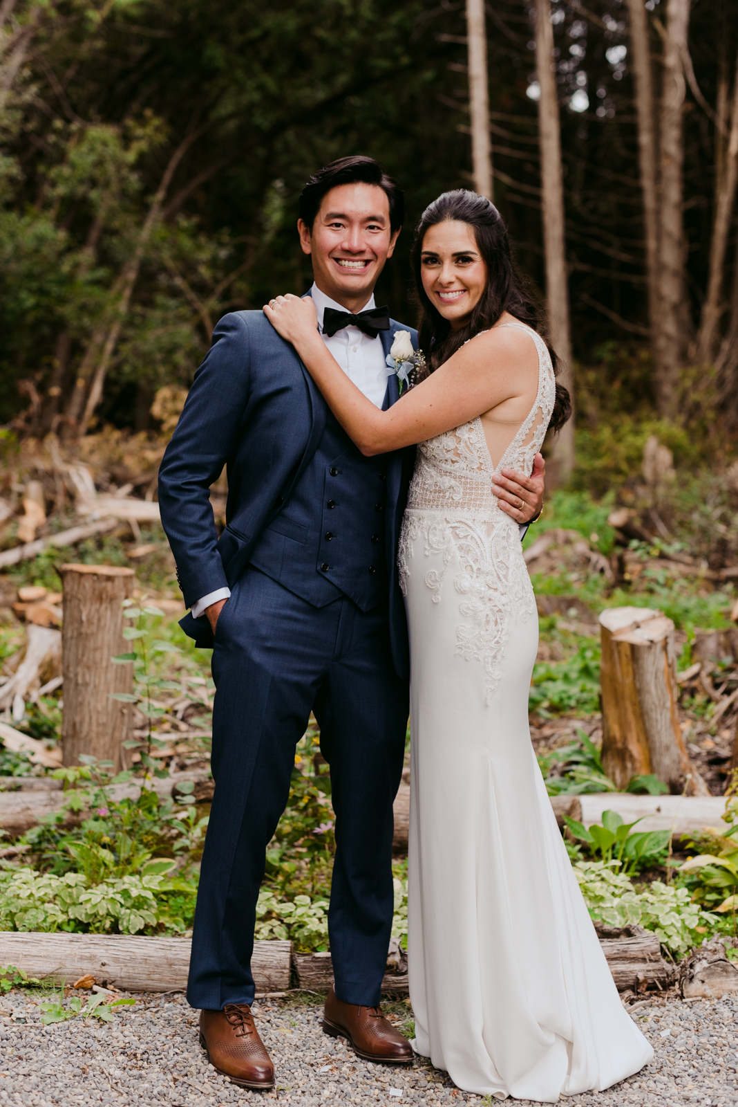 bride and groom in a forest of chopped logs