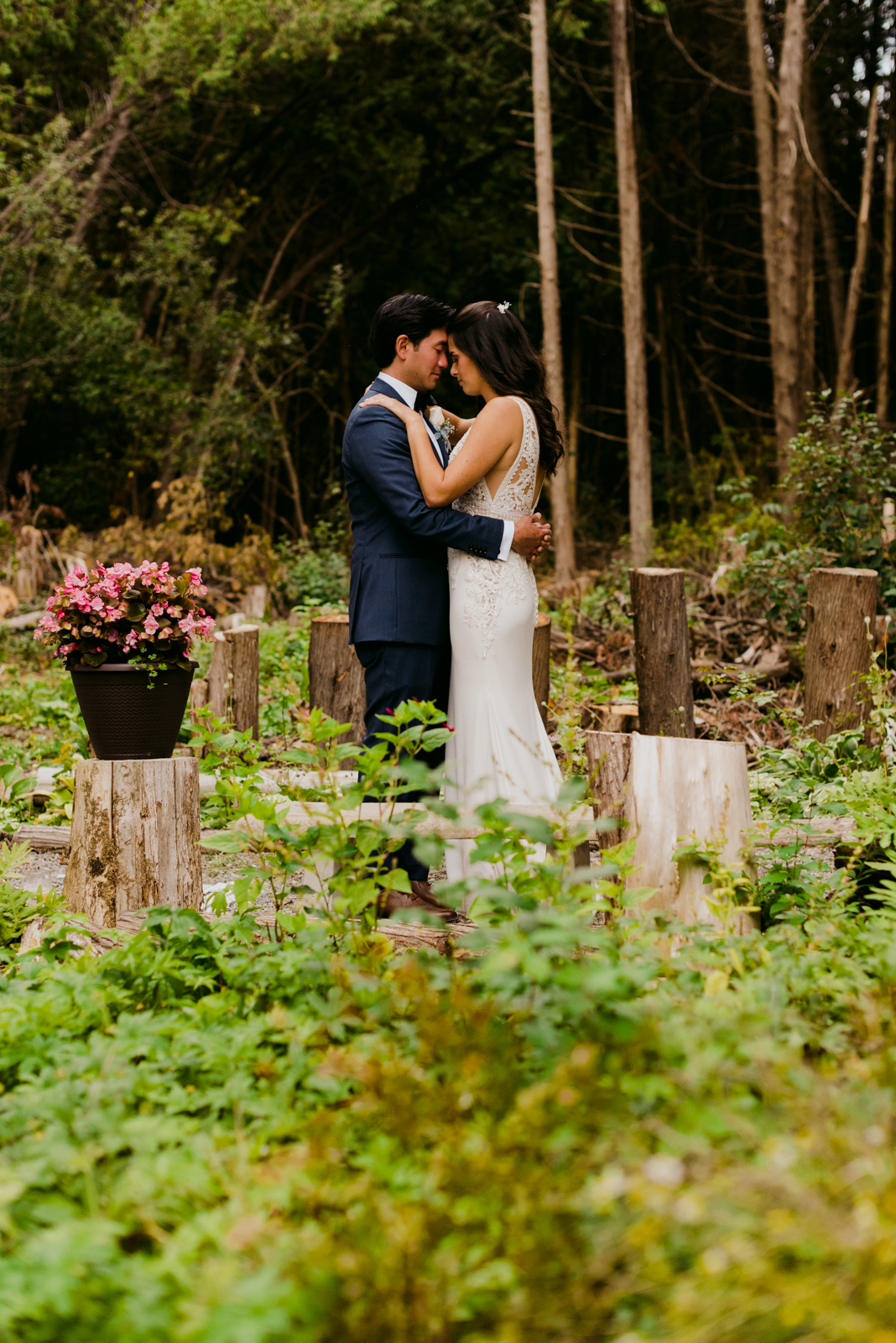 bride and groom in a forest of chopped logs