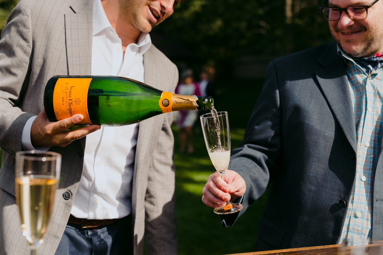 brother of the groom pouring Veuve Clicquot champagne