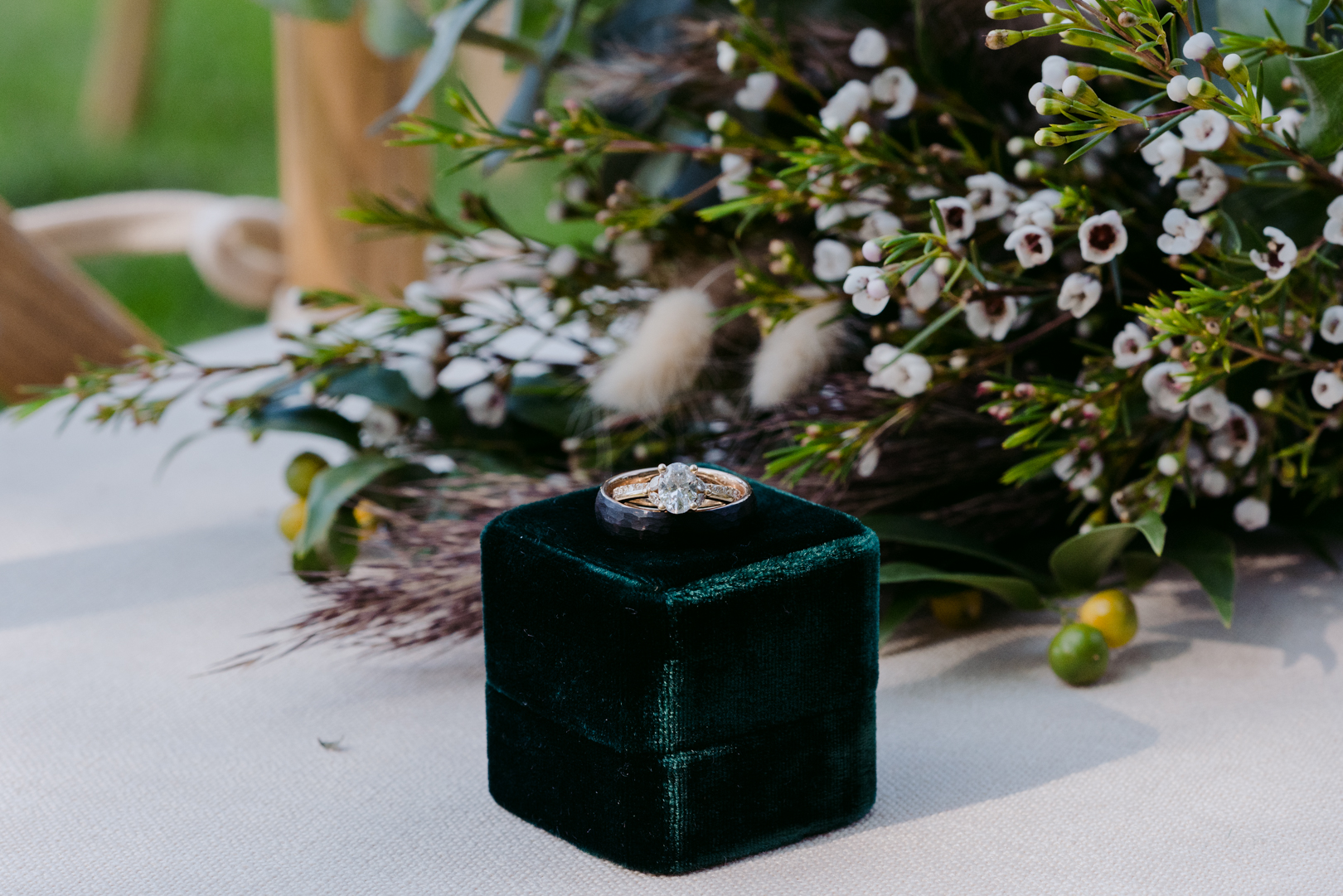 wedding rings resting on green velvet ring box