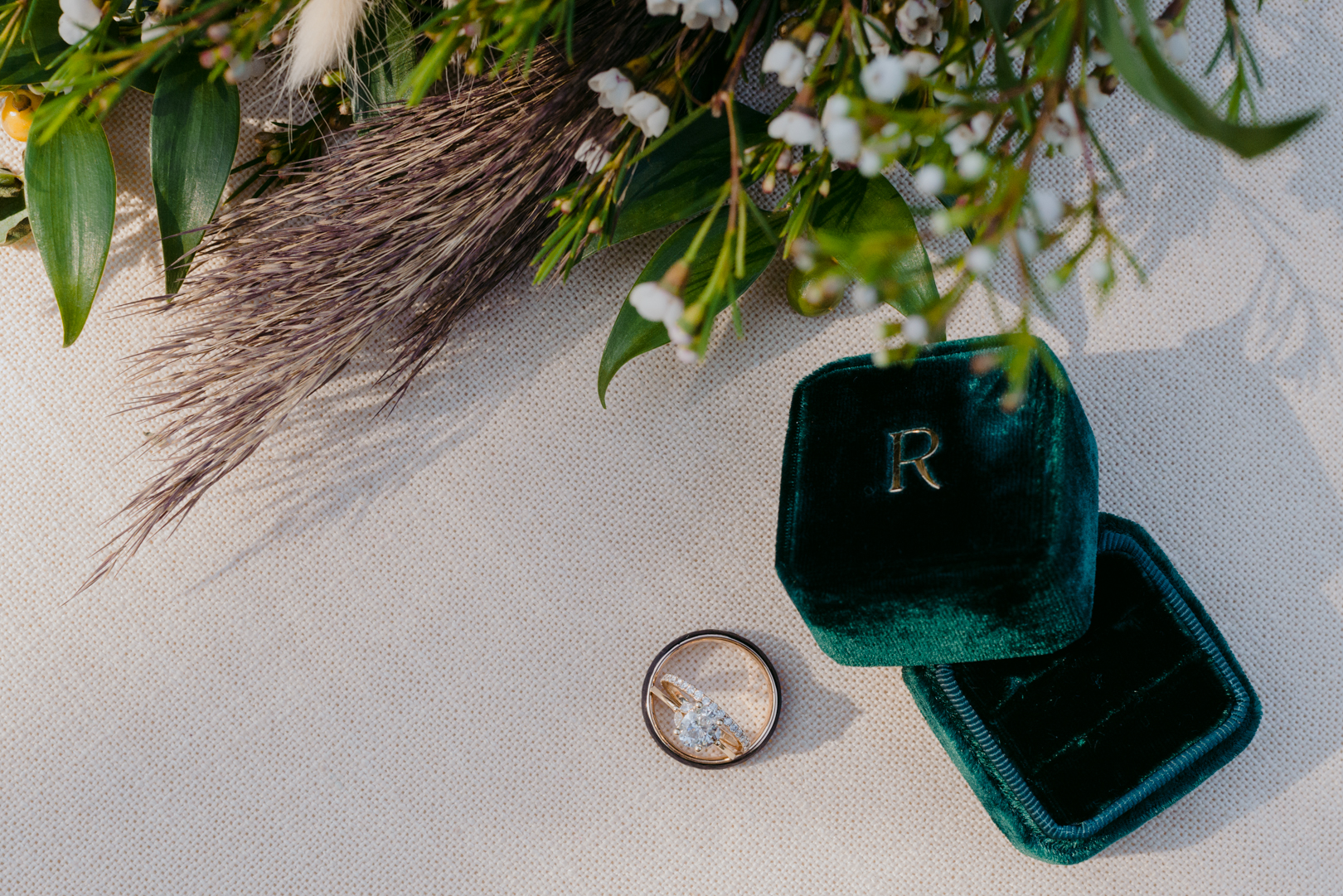 wedding rings with dark green velvet ring box with flowers