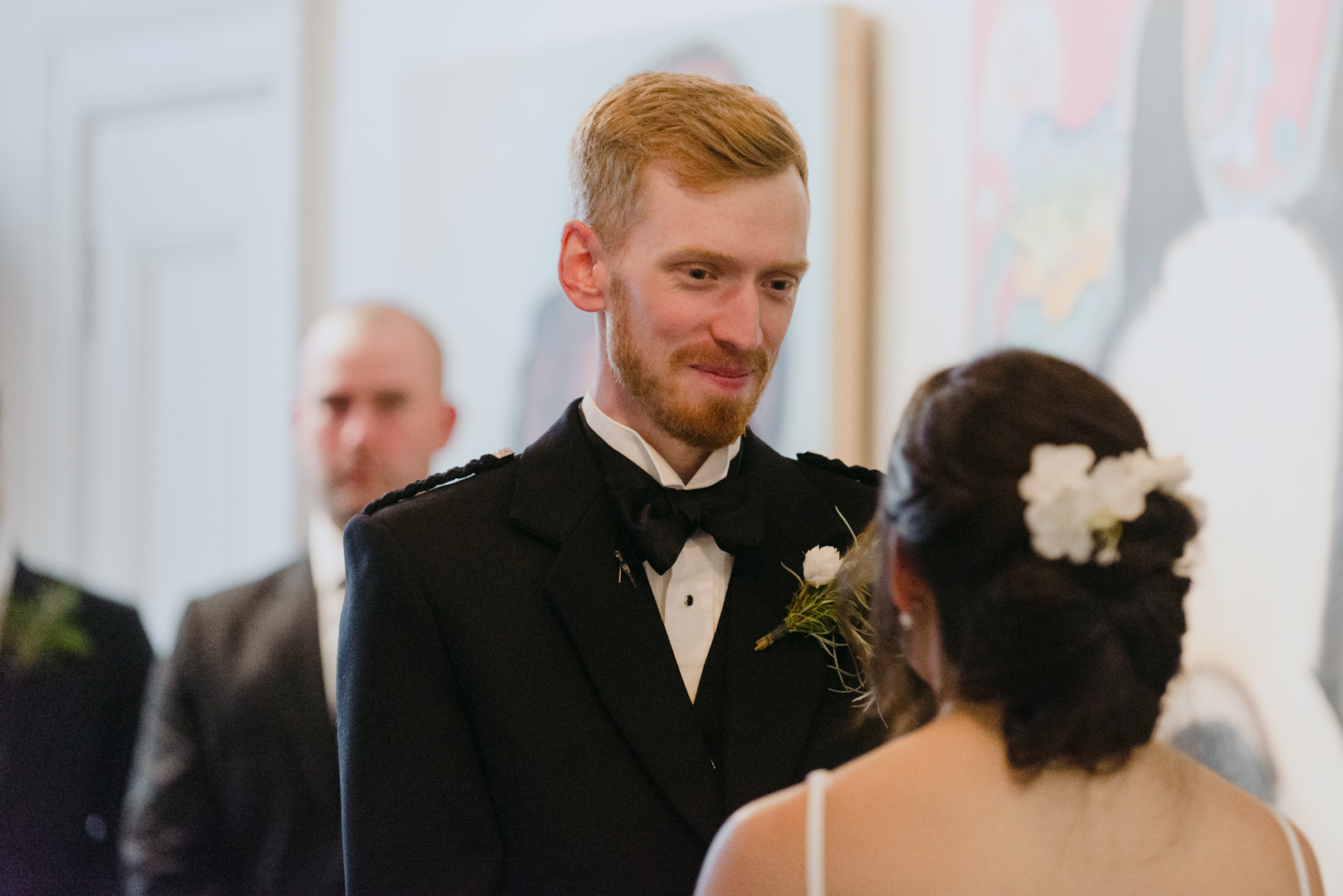 groom looking at bride standing at the altar at Orange Art Gallery wedding