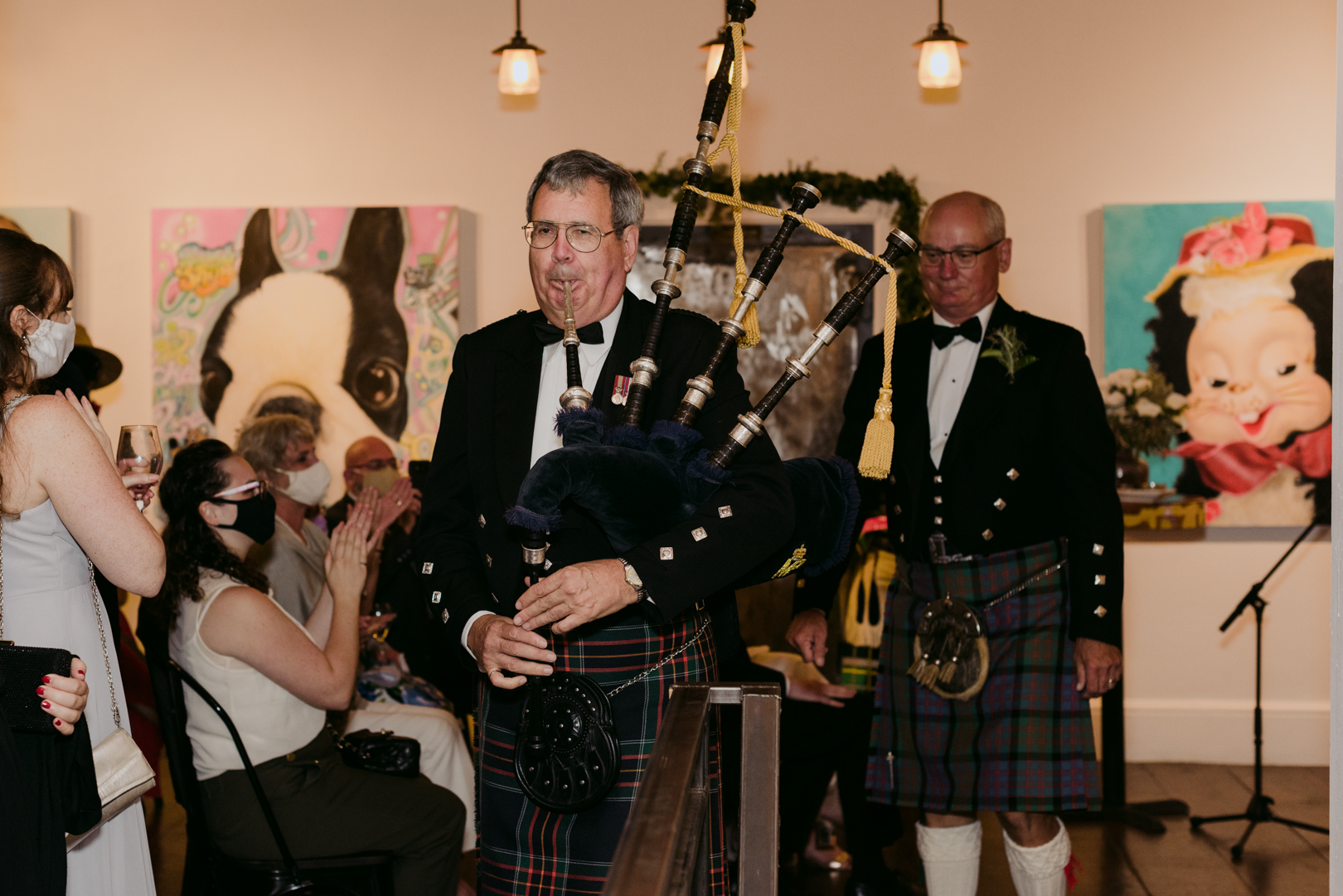 bagpiper escorting Scottish father of the groom to his speech