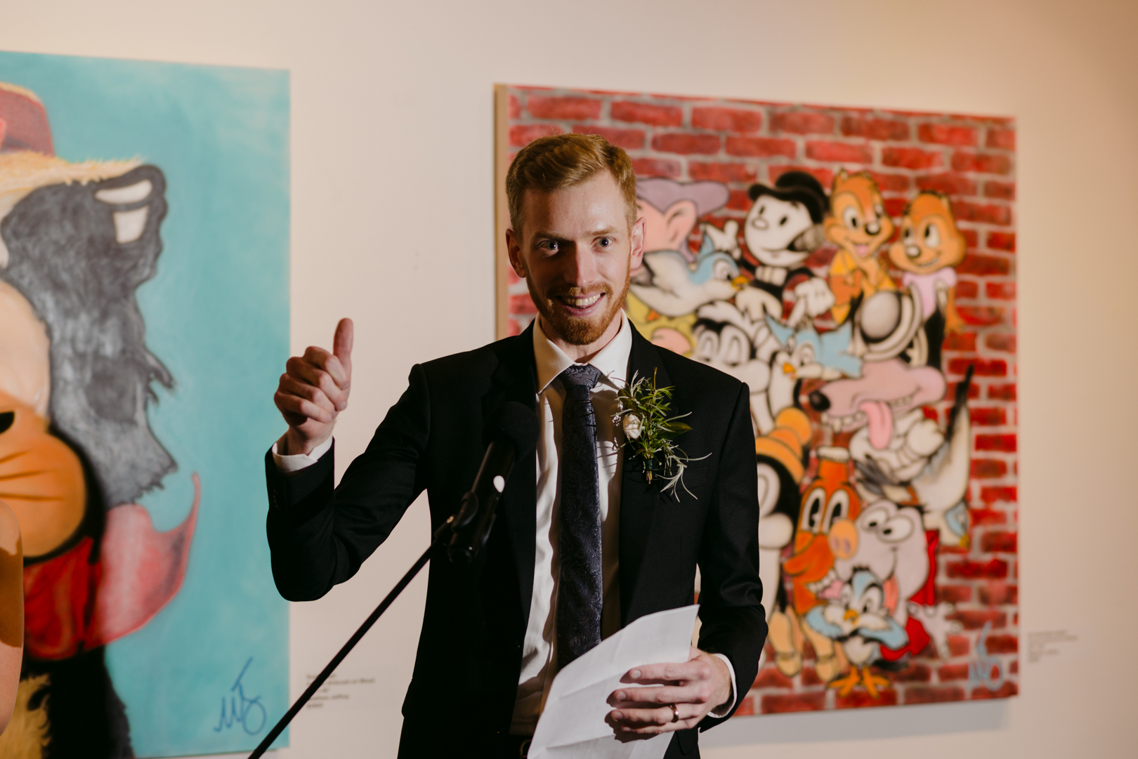 groom giving thumbs up during his speech