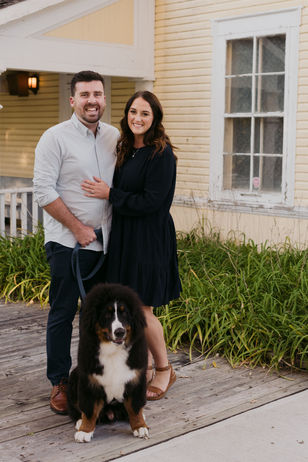 engagement photos with dog in front of yellow house