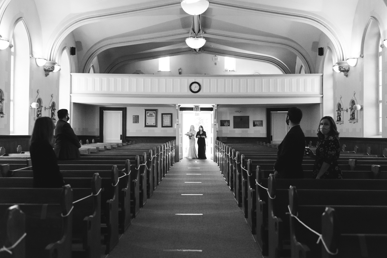 bride and her mother entering the church to walk down the aisle