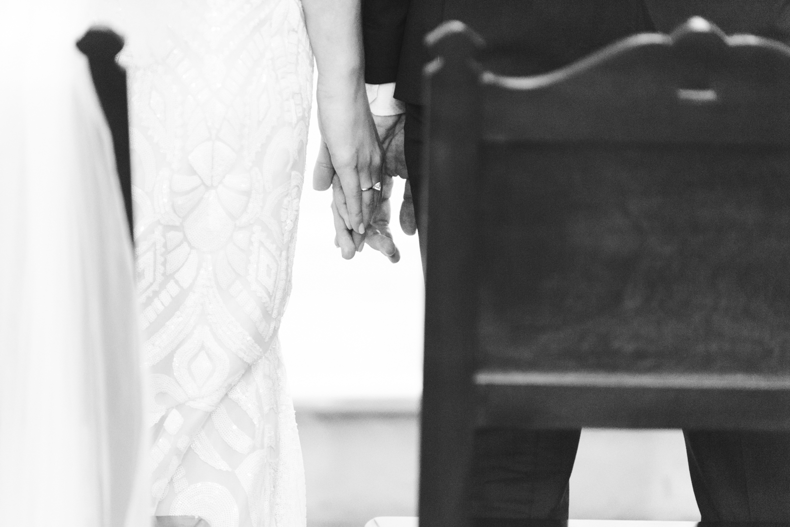 bride and groom holding hands during church wedding ceremony