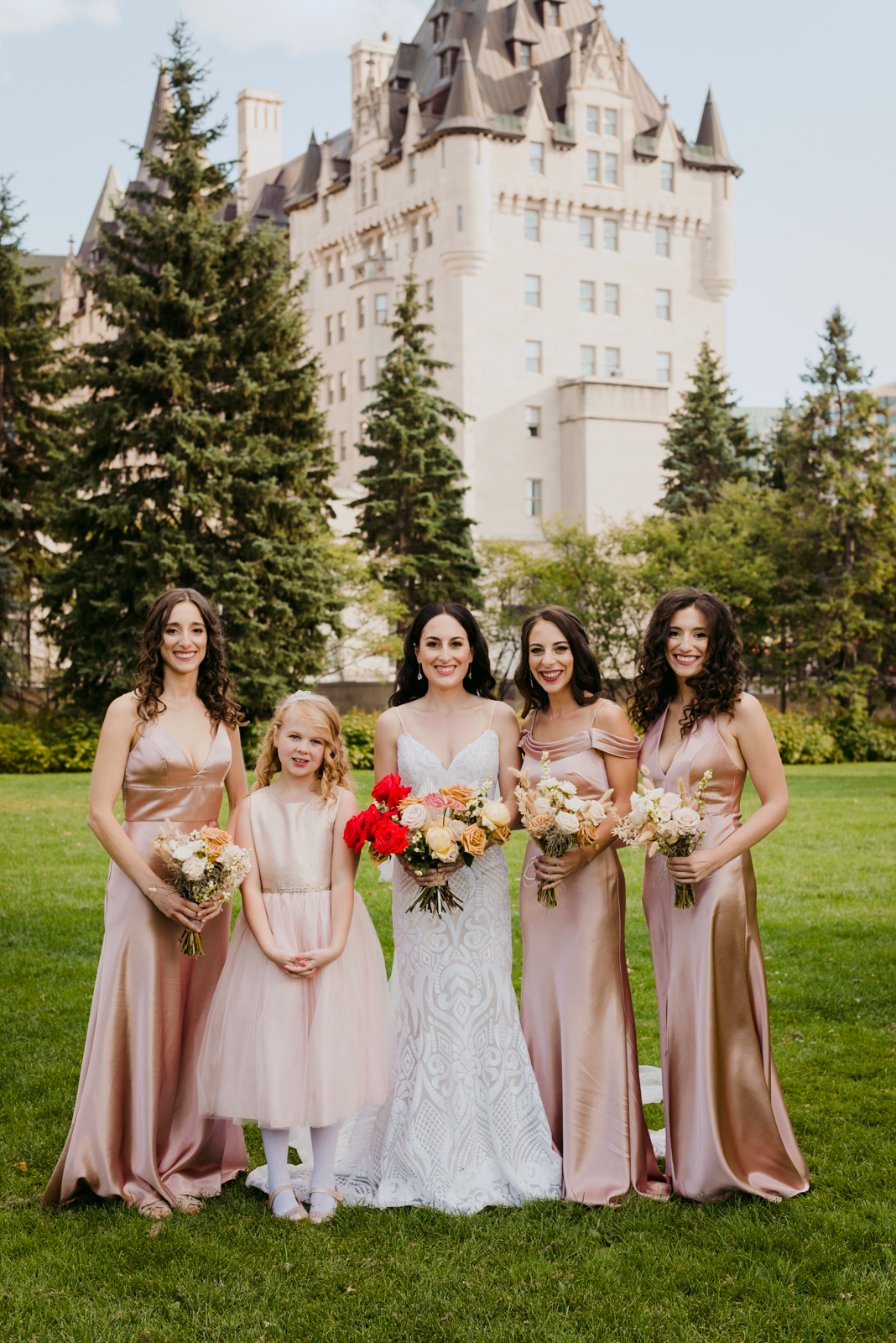 bride and bridesmaids in majors hill park outside of chateau laurier