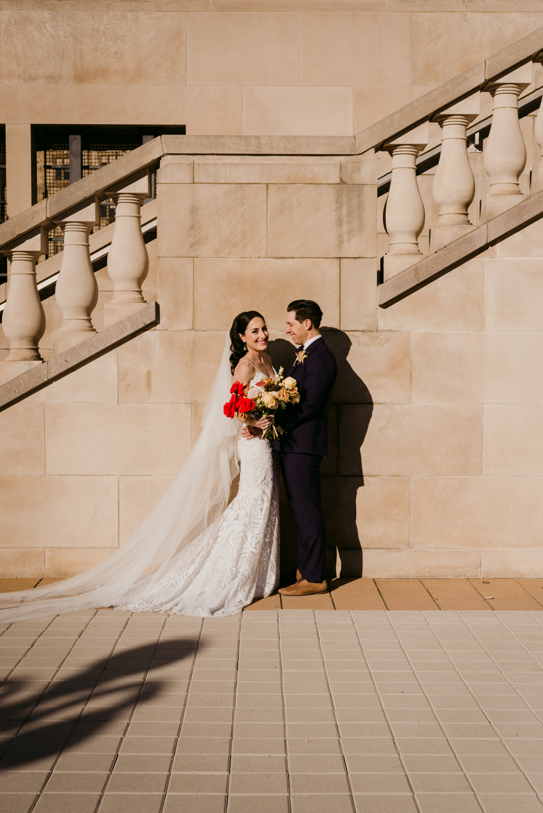 bride and groom by stone staircase by chateau laurier