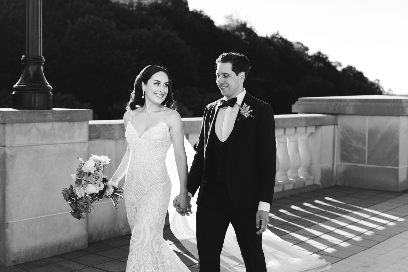 bride and groom holding hands walking along terrace of the chateau laurier