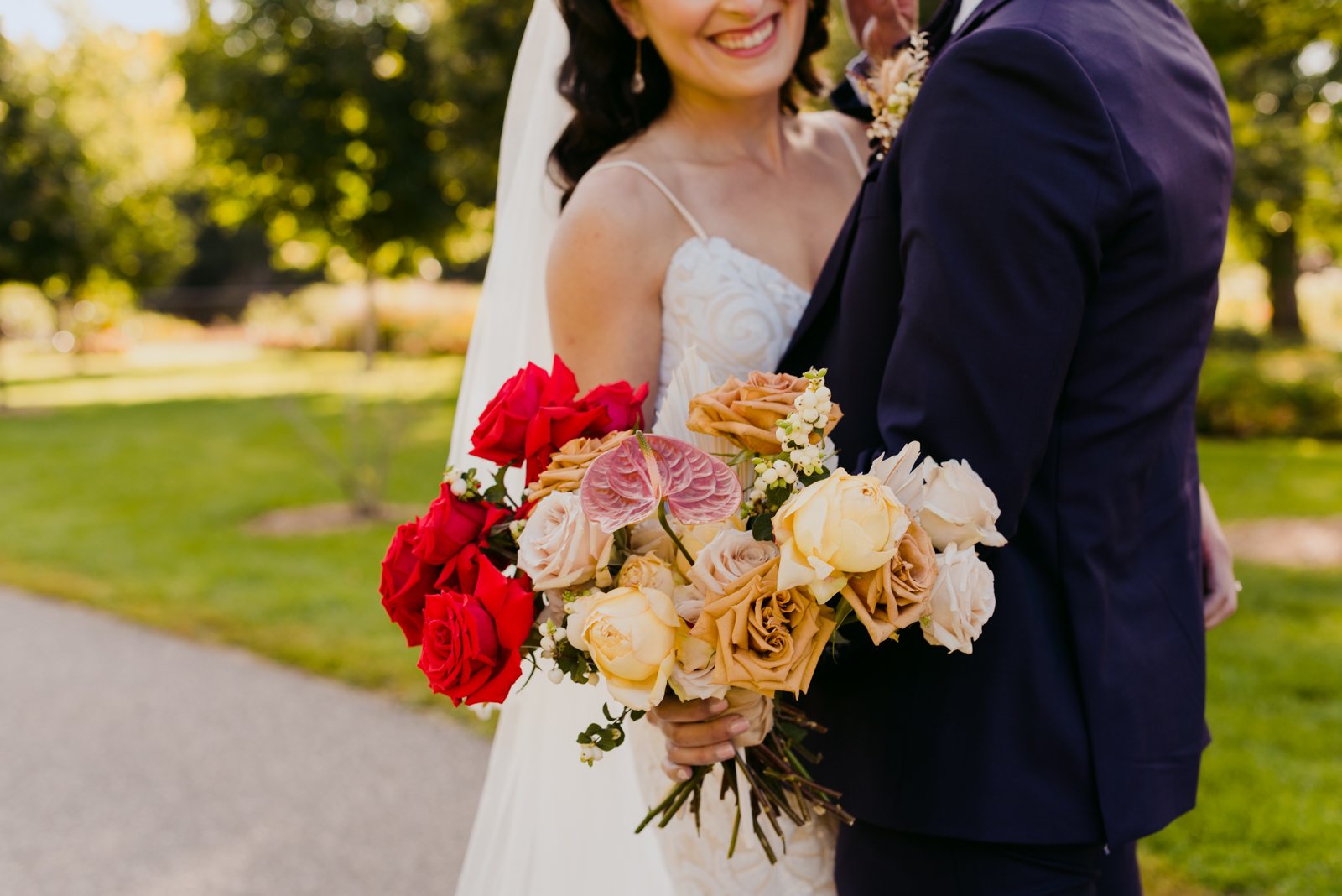 bride and groom in majors hill park with wild rose bouquet