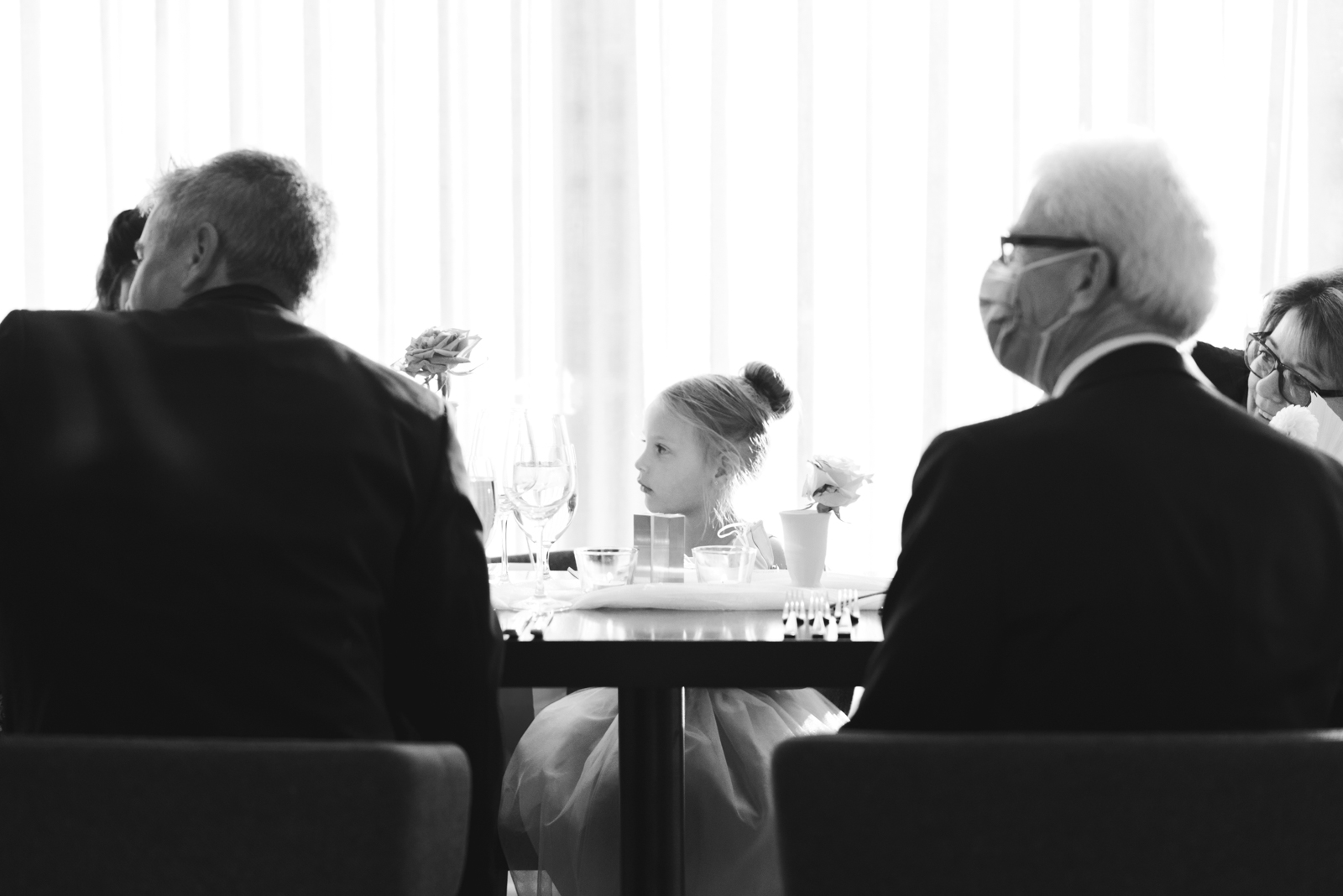 flower girl sitting at table in black and white