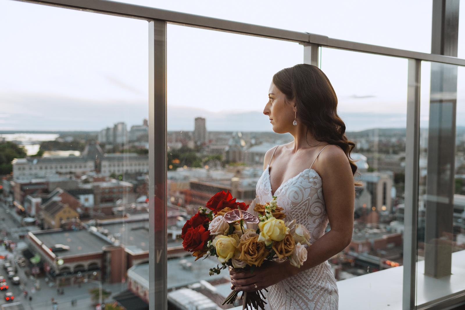 bride holding wild bouquet at sunset in the presidential suite of the andaz hotel