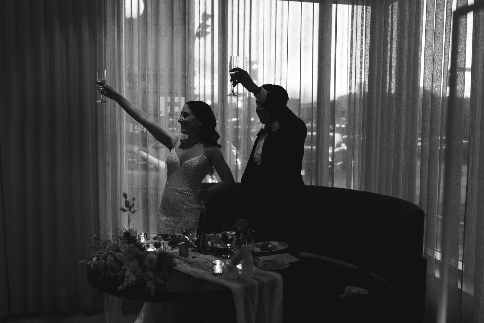 bride and groom toast in black and white