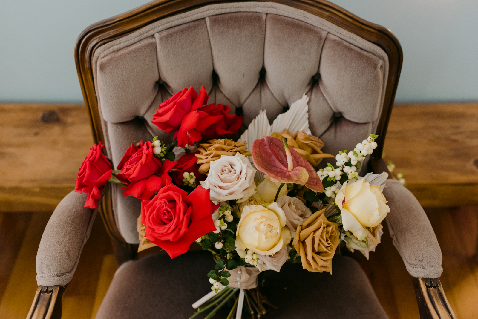 Pollen Nation wedding bouquet on vintage velvet chair