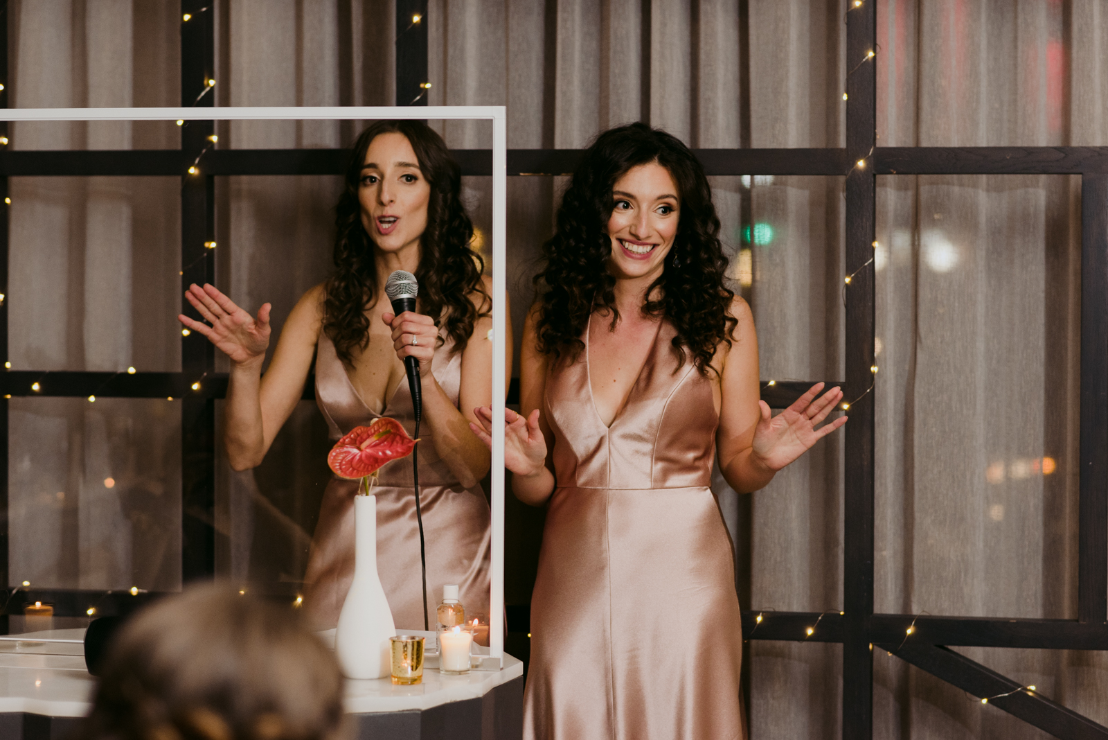 bridesmaids rapping a song for the bride and groom during wedding reception