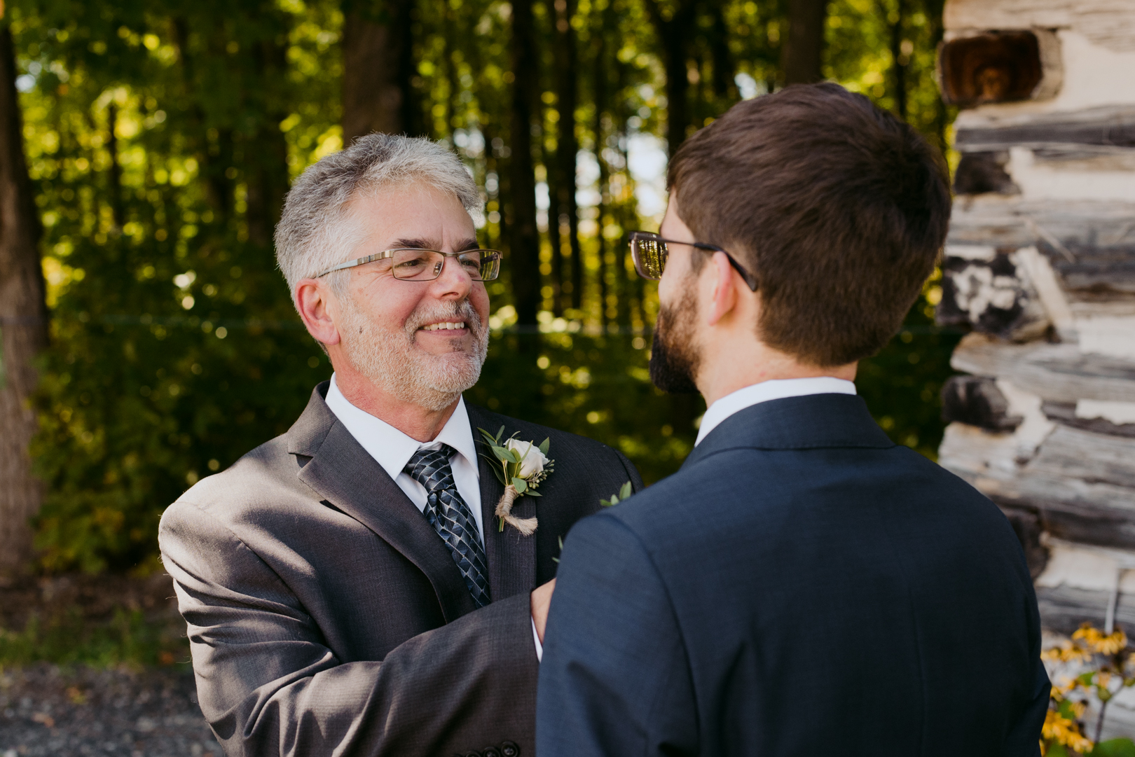 groom's father adjusting the groom's tie