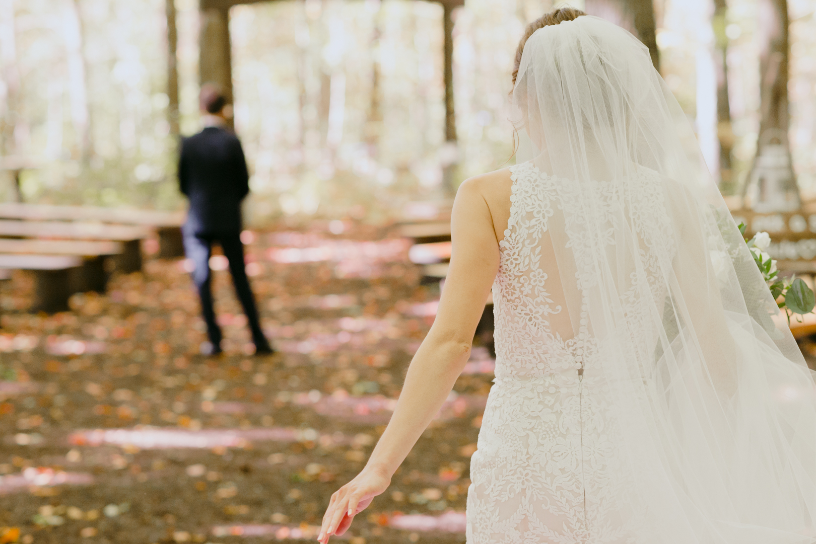 bride walking in the forest for first look