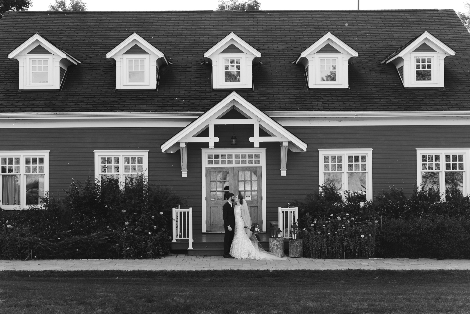 bride and groom in front of temples sugar bush in black and white