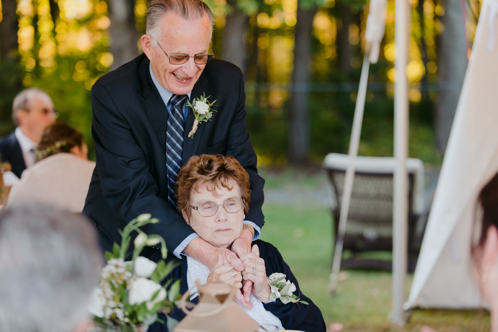 grandparents cuddling during wedding reception