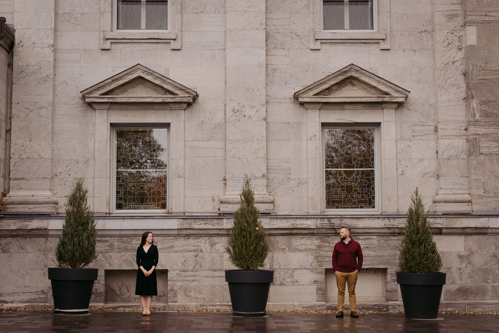 engaged couple standing in front of rideau hall windows