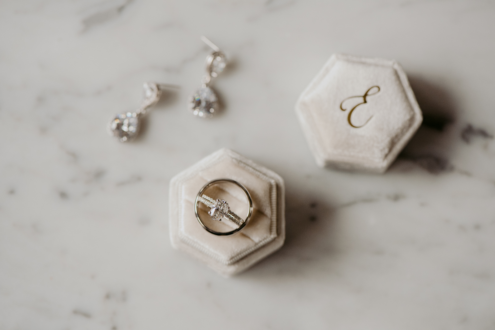 ring box and earrings on marble table