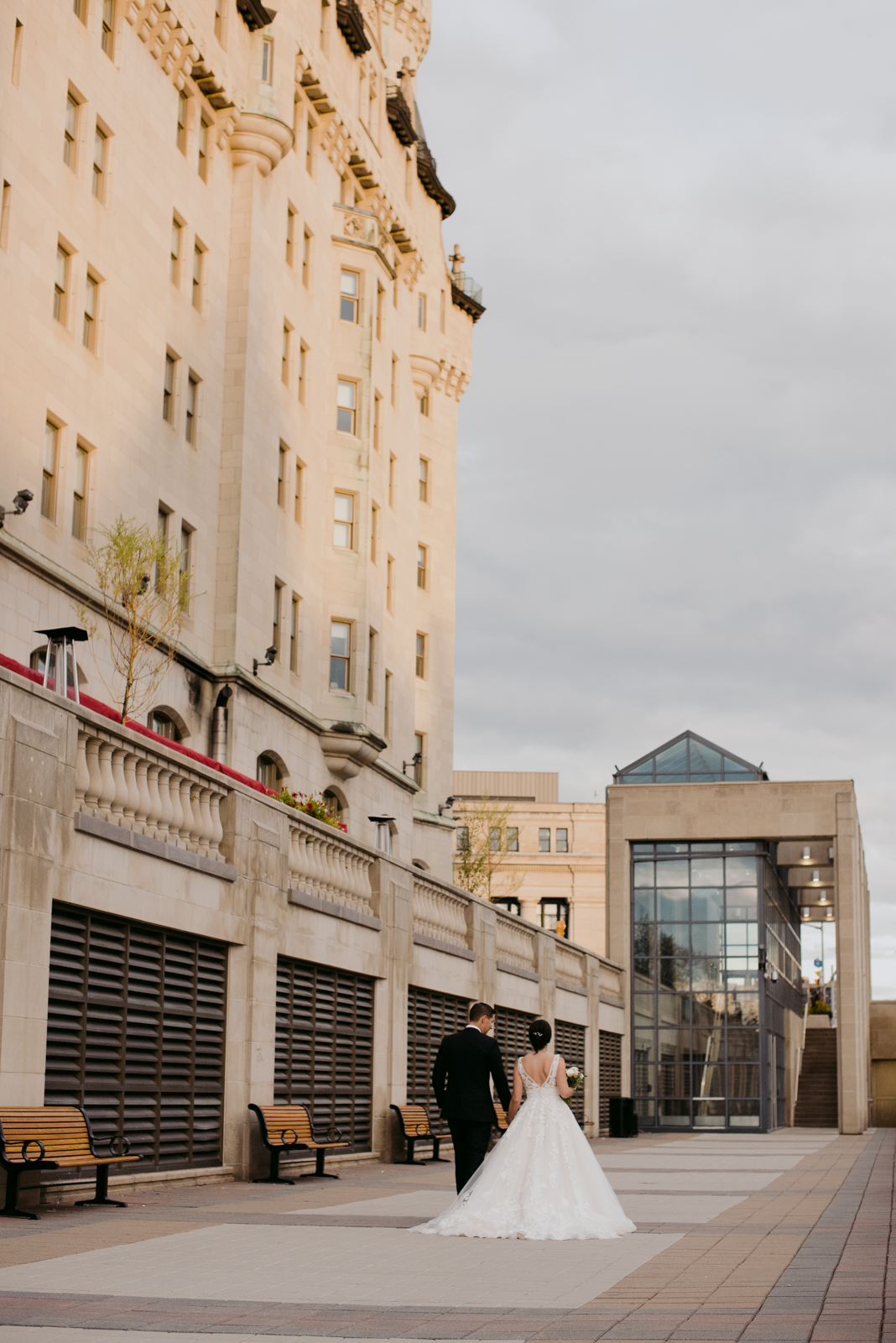 bride and groom walking down the pavilion of the chateau laurier