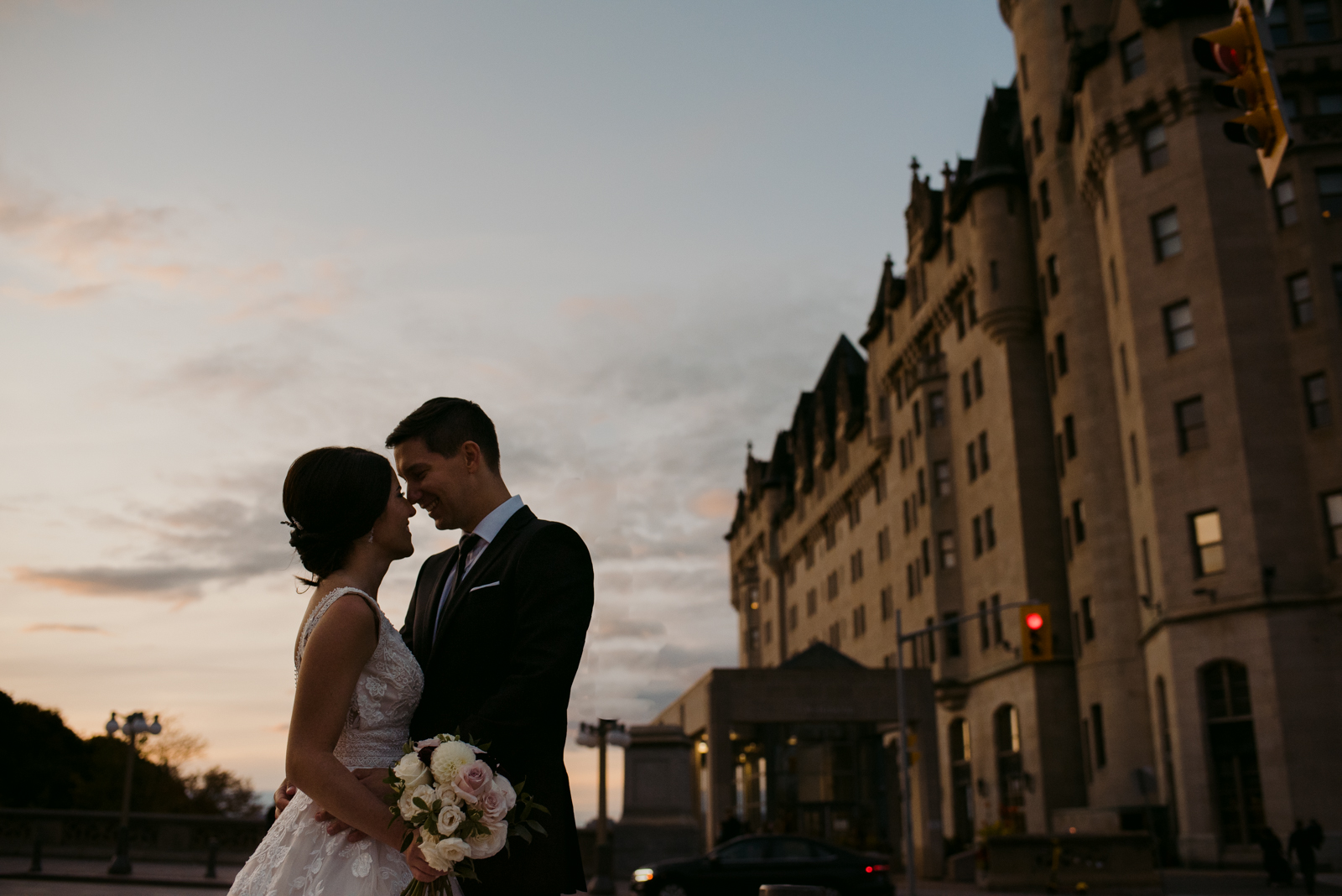 bride and groom silhouette outside the Chateau Laurier at sunset