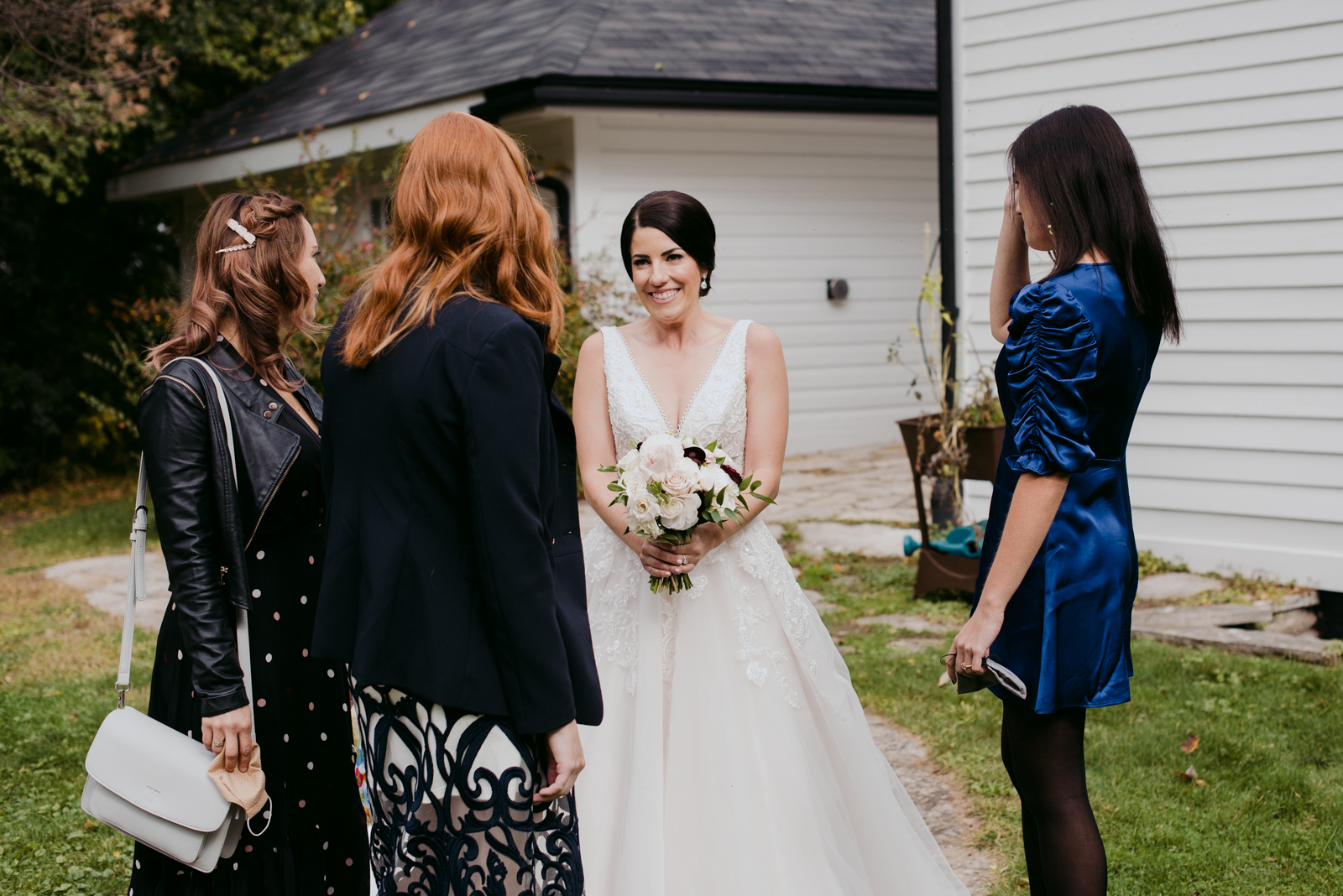 bride seeing her friends for the first time before wedding ceremony