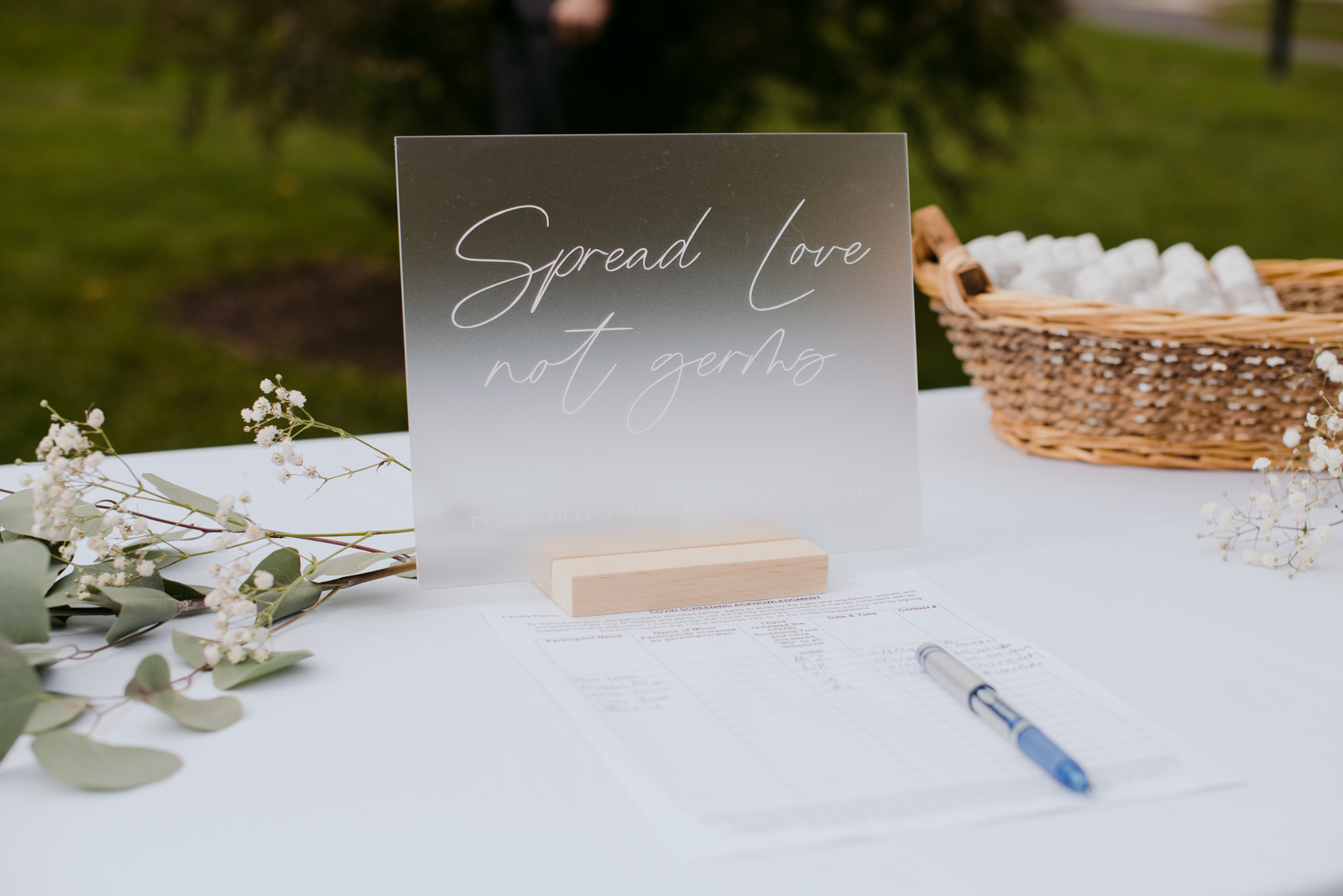 Spread love not germs sign at covid wedding reception
