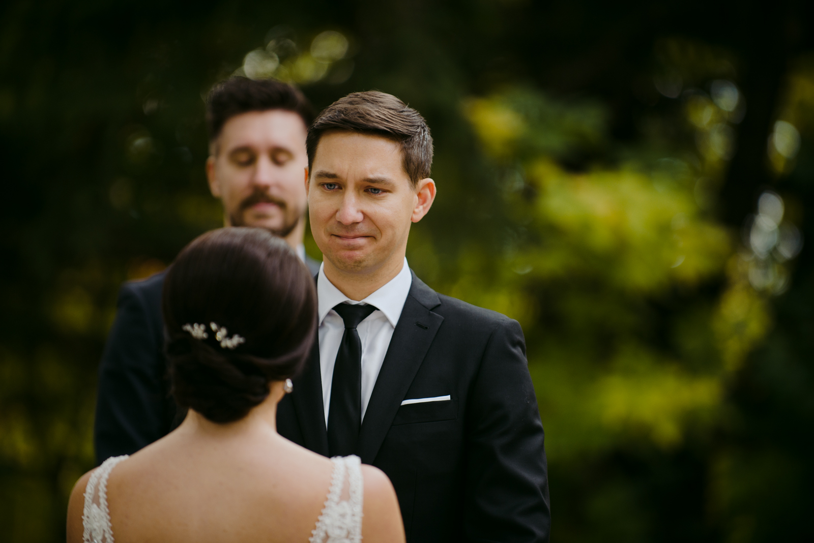 groom tearing up during outdoor wedding ceremony