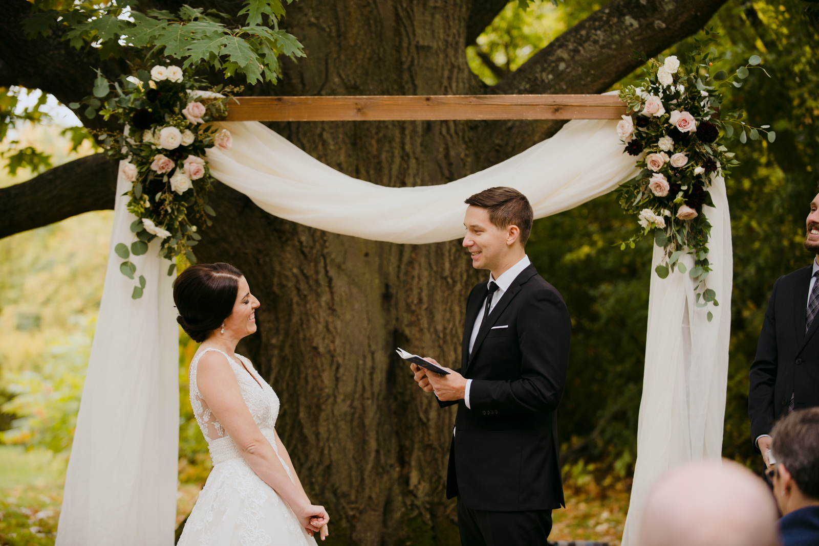 groom reading his vows during outdoor wedding ceremony