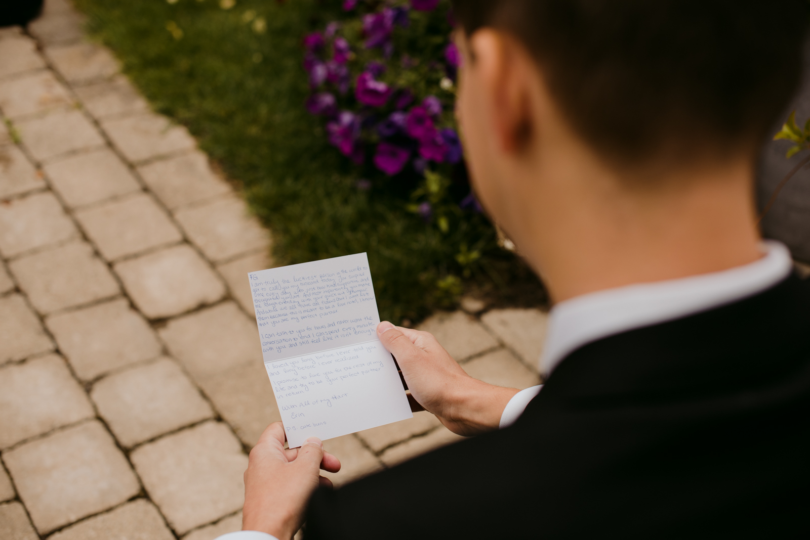 groom reading a letter from the bride before ceremony