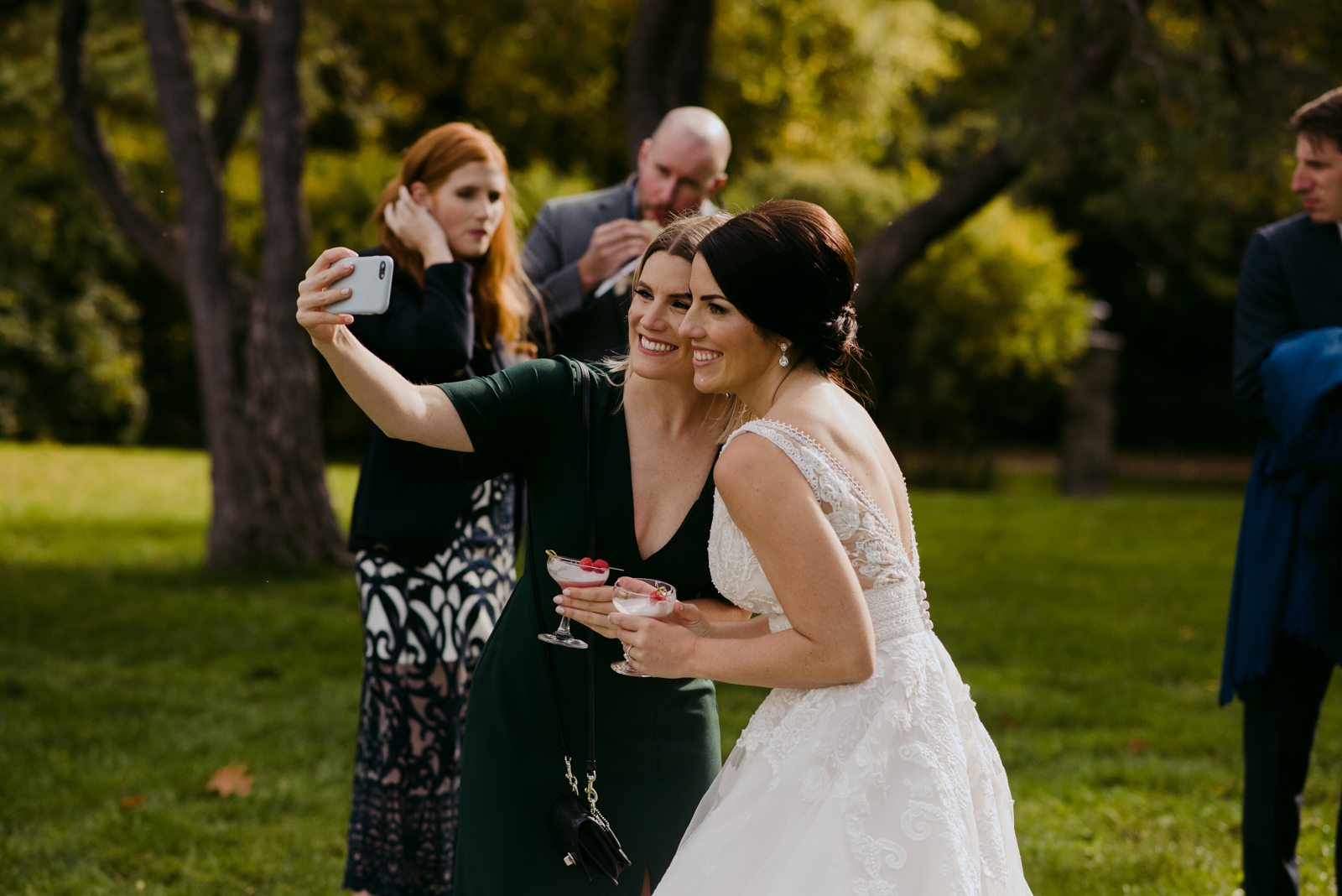 bride taking a selfie with a wedding guest