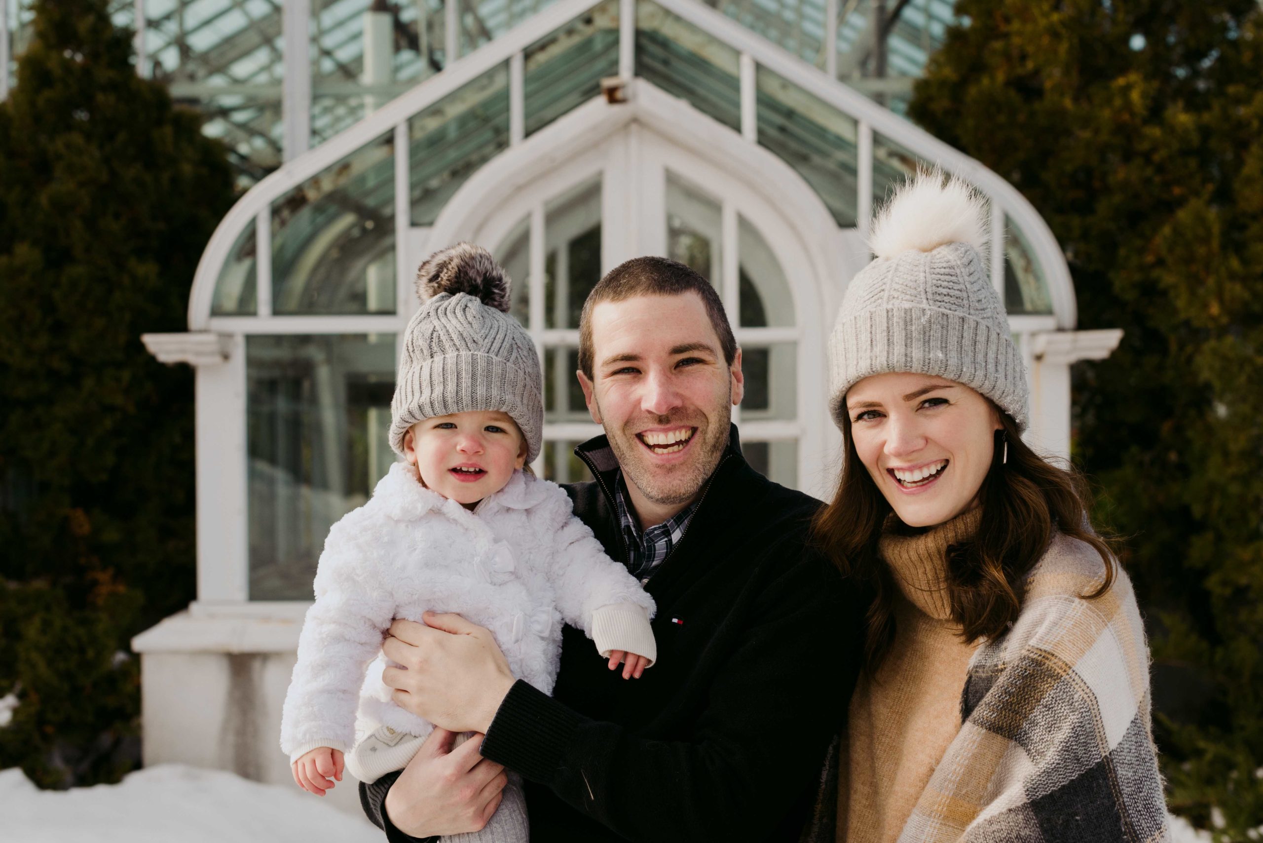 ottawa family wearing toques in front of experimental farm greenhouse
